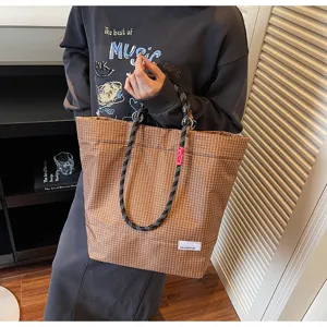 Classic brown plaid canvas tote bag with durable rope handles for daily casual wear.