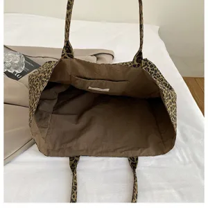 Detailed view of the leopard print canvas tote bag interior showing large capacity and pocket.