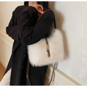 Fluffy white faux fur shoulder bag featuring brown leather strap and metal lock closure