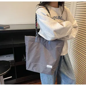 Detailed view of casual plaid tote bag with rope strap, stylish large capacity shoulder bag.