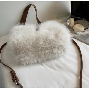 Detailed view of the fluffy white plush shoulder bag, highlighting soft fur and brown strap.