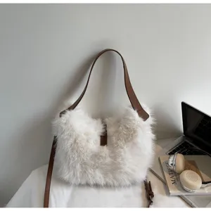 Detailed view of fluffy plush bucket bag with leather strap and soft white faux fur texture.