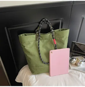 Green grid canvas tote bag with stylish black rope handles, large capacity casual shoulder bag.