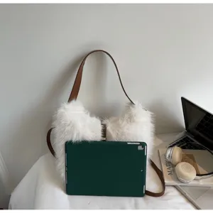 Detail view of a fluffy white faux fur bucket shoulder bag featuring stylish brown straps.