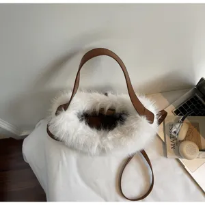 Plush bucket bag detail view, white faux fur with brown leather strap for women.