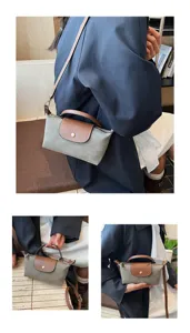 Vista detallada del bolso cruzado de ante para mujer con asa superior y solapa elegante.