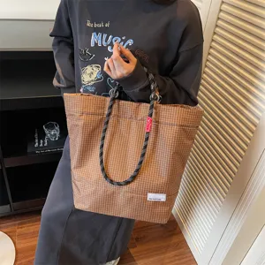 Stylish brown plaid tote bag for men and women, large capacity shoulder handbag with rope handles.
