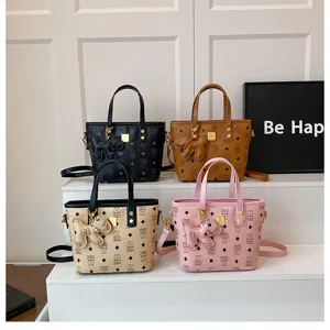 Fashion bucket bag women detail shot showcasing cute dog charm and classic monogram pattern options.