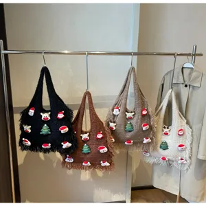 Detail shot of knitted tote bags with Christmas patches, fuzzy fringe, and festive holiday design.