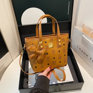 Stylish brown monogram bucket bag for women, classic retro shoulder bag with cute bear charm.
