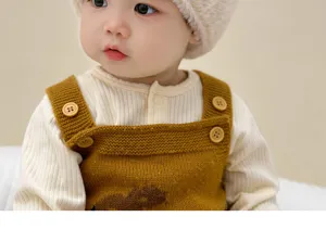 Kids winter plush hat detail, cozy warm knit bear design for baby boys and girls outdoor wear.
