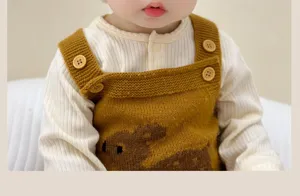 Infant knitted overall featuring cute bear pattern and wooden buttons, warm winter wear for toddlers.