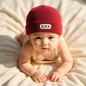 Cute baby winter knit beanie hat, soft warm red ribbed cap for toddlers, comfortable daily wear.