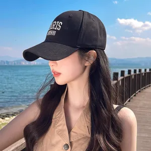 Close-up detail of the black cotton baseball cap featuring stylish letter embroidery.