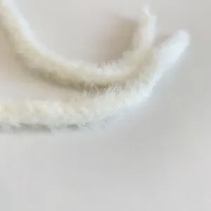 White plush fuzzy hat strap detail close-up showcasing soft winter warm texture and quality.