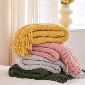 Cozy knitted throw blanket with fringe, soft decorative blanket for sofa, bed and couch decor.