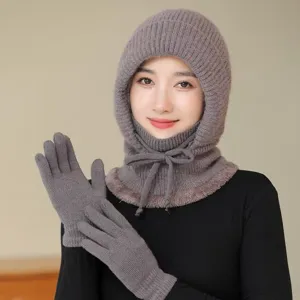 Detail shot of winter warm knitted balaclava cap and gloves set in grey fleece lining close up