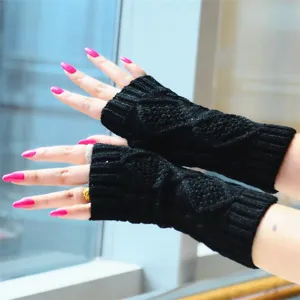 Black knitted arm warmers detail shot, textured diamond pattern elastic sleeves for winter.