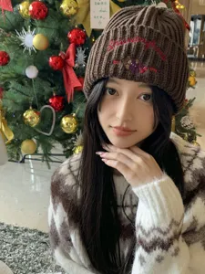 Detailed view of the cute brown knitted beanie featuring sweet bear embroidery and ribbed texture.