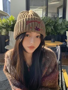 Cozy brown knit beanie for women with cute bear embroidery, perfect for autumn and winter warmth.
