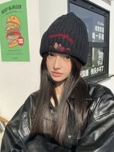 Winter knitted beanie hat for women featuring cute cartoon bear embroidery, warm and stylish.