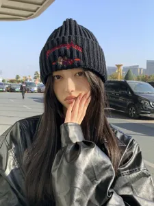 Cozy black knitted beanie hat featuring cute embroidered bear design for autumn and winter warmth.