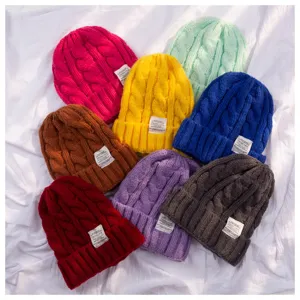 Colorful knit beanies detail view, winter warm cable knit caps assortment close up display