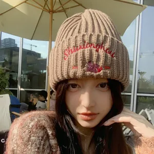 Cozy brown knit beanie hat for women, featuring cute embroidered bear and autumn winter warm style.