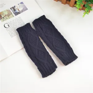 Close-up of dark blue knit arm warmers featuring classic cable diamond texture design.