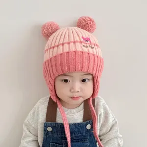 Cute baby winter knit ear-flap hat with pom-poms and cute bear embroidery design warm.