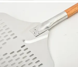 Perforated aluminum pizza peel with wooden handle for baking bread and pizza tools.