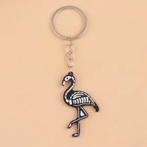 Close-up detail of the cute skeleton flamingo acrylic keychain pendant, smooth surface finish.