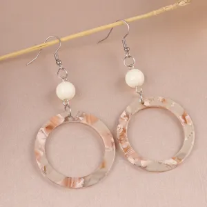 Detail shot of retro leopard print acrylic round dangle earrings, stylish chic jewelry for women.