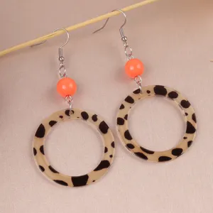 Retro leopard print acrylic dangle earrings with vibrant orange beads for women fashion.