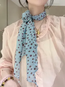 Chic light blue brown polka dot long silk scarf neck accessory detail view stylish women
