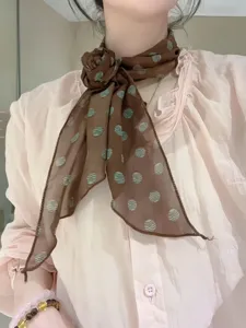 Brown polka dot long silk scarf neck accessory, elegant printed hair band detail view.