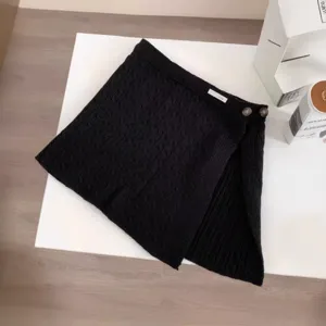 Black cable knit layered half skirt for women, stylish button mini skirt fake hem.