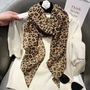 Detailed shot of brown leopard print long silk scarf, versatile hair ribbon or neck accessory.