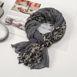 Grey floral voile scarf detail view, wrinkled lightweight fabric, versatile spring accessory.