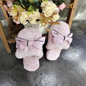 Korean style pink plush cotton slippers for women featuring a cute oversized bow and cozy design.