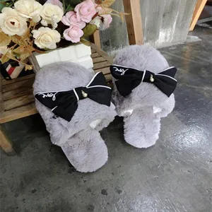 Cozy grey faux wool women's slippers featuring a chic black bow detail for home wear.