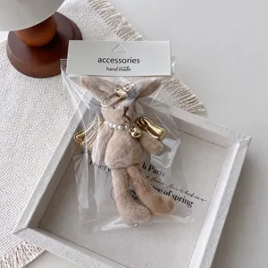 Plush rabbit bunny keychain charm detail, cute fluffy toy pendant for bags and phone cases.