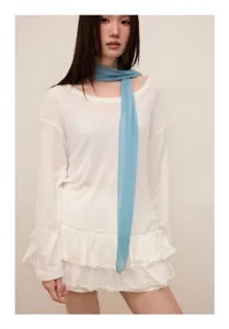 Detailed close-up shot of a light blue pleated narrow scarf, elegant neck ribbon accessory.