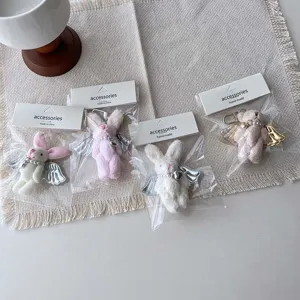 Cute plush bunny and bear keychains with angel wings and pearls for phone cases and bags.