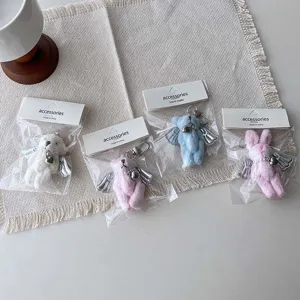 Cute winged plush bear and rabbit keychain details, featuring pearl decor and fluffy plush.