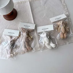 Cute plush bear rabbit keychain pendant with pearl angel wings, sweet bag hanging accessory detail view