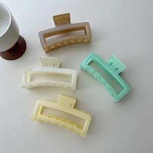 Glitter jelly hair claw clip detail shot, featuring four colorful translucent rectangular catch.