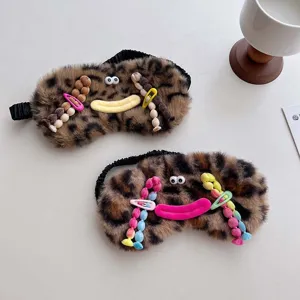 Cute plush leopard sleep mask with funny face and bead hair clips for comfortable sleep and rest.