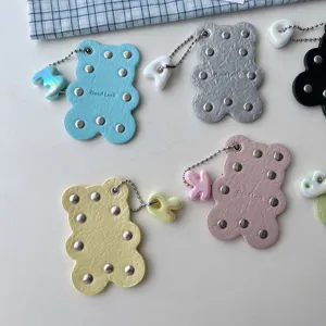 Cute PU leather bear keychain with metallic studs and letter charm, stylish bag charm.