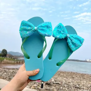 Close-up view of stylish women's sequin bow flip-flops, perfect for beach and summer casual wear.